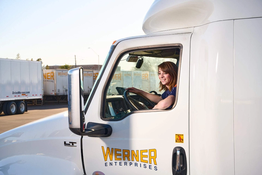 Team Werner Network truck drivers beside their rig